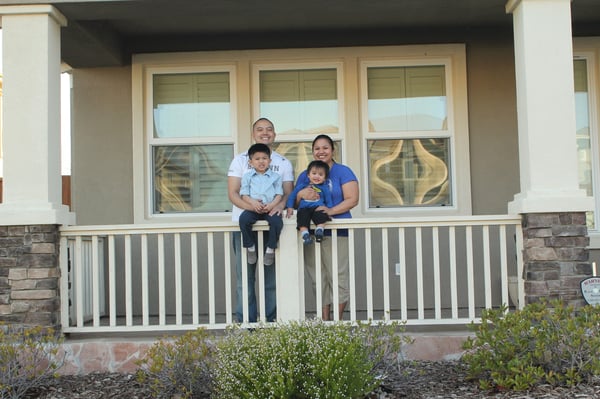 Randy V. and his family in front of their dream home. 