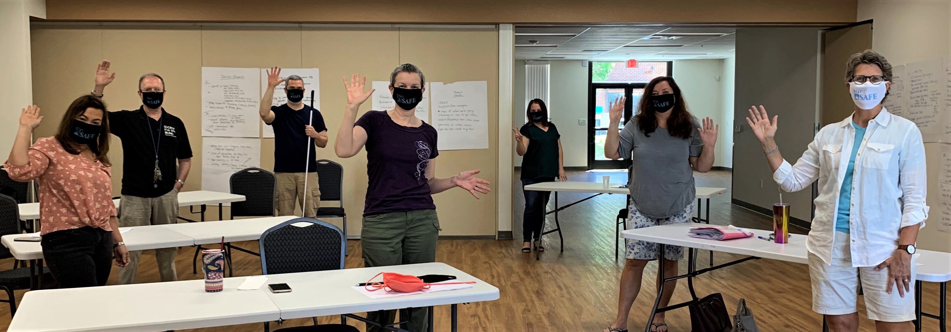 Members of the Society for the Blind pose wearing their Stay SAFE masks at a planning meeting