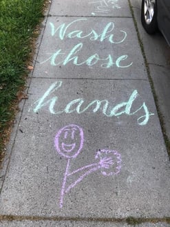 Sidewalk chalk says wash those hands